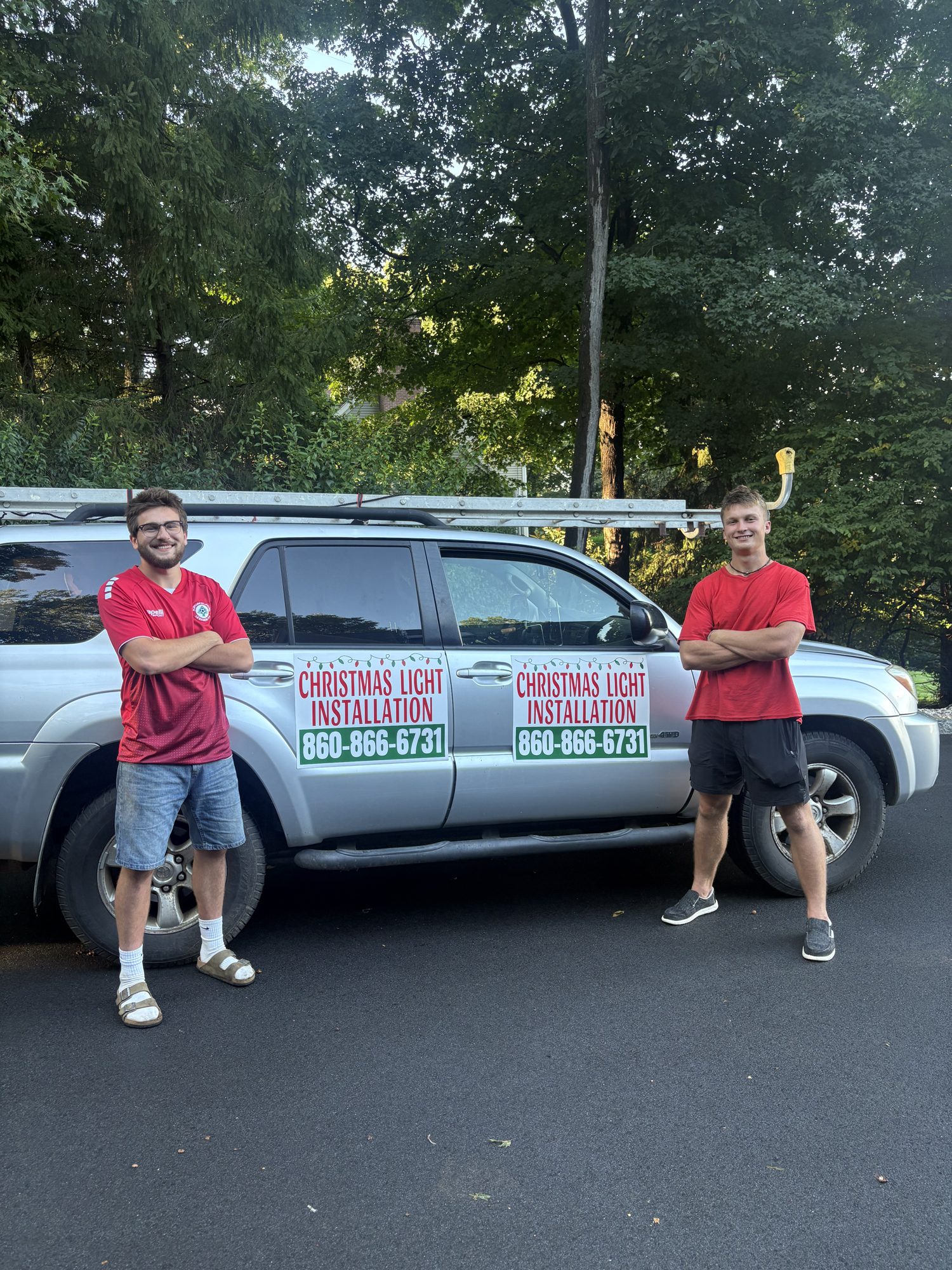 Zack Hellwinkle and Trey Medonis standing in front of their HellDonis work truck